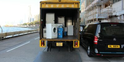 white front-load washer in yellow delivery truck