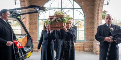 a group of people standing next to a car